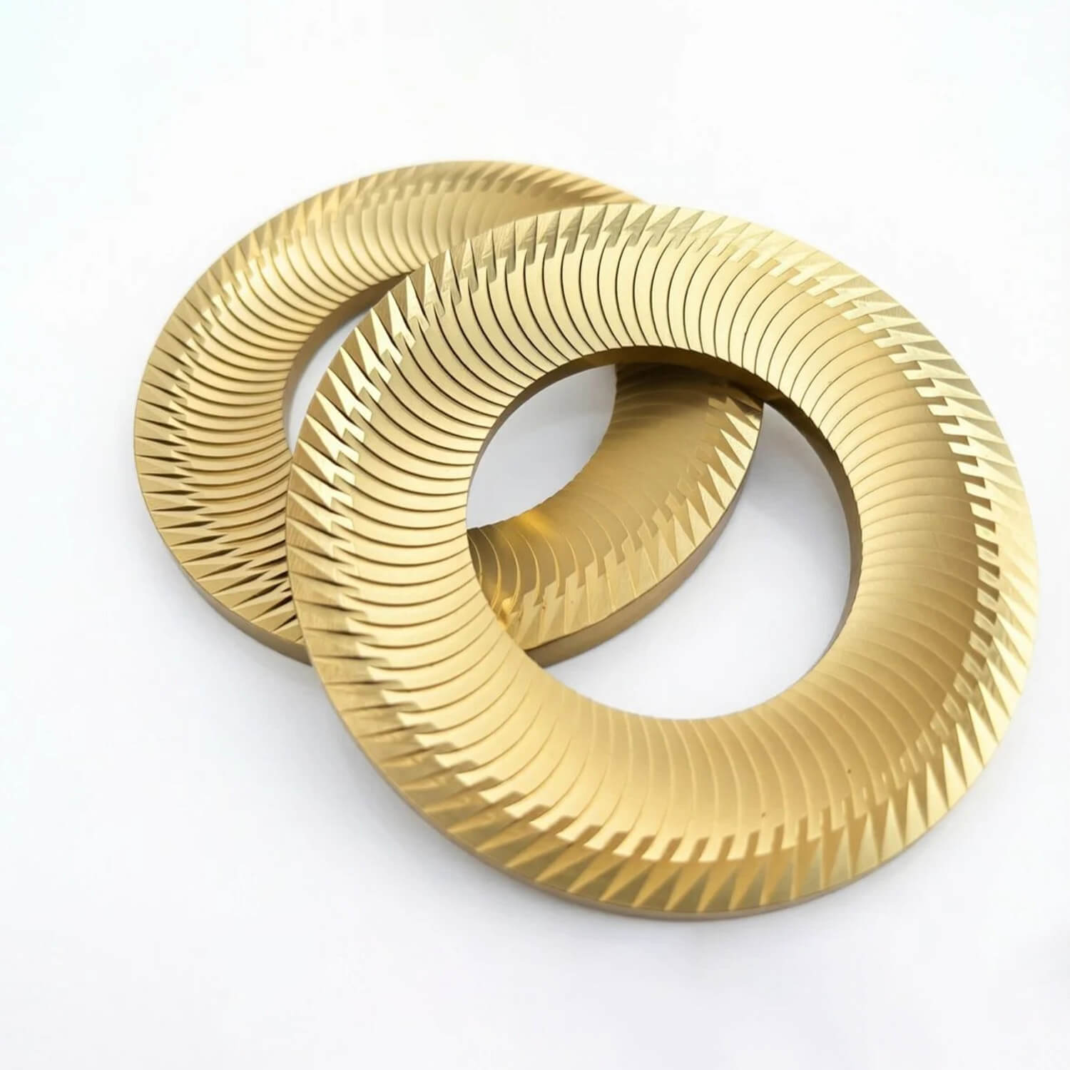 Close-up of golden flat burrs replacement parts for high-end espresso coffee grinders
